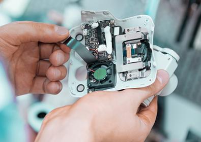 Close up of hands working on electronics (drone)